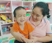 Image of a child smiling with an adult